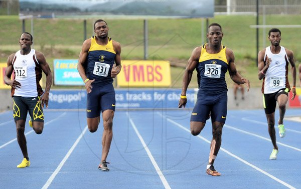 Ian Allen/Staff Photographer
Rusheen McDonald second right of Utech winning the Men 400m finals ahead of his teammate Faedian Royes second left, Alvin Green left from G.C.Foster College and Kegan Campbell right from G.C.Foster College during the VMBS Intercollegiate Track and Filed Championships 2014 at the UWI/Usain Bolt Track.
