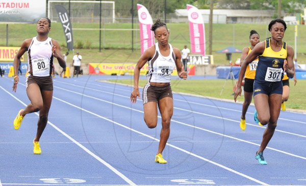Ian Allen/Staff Photographer
Elaine Thompson right of Utech winning the Women's 100m finals ahead of Audra Segree centre and Kedisha Dallas left both from G.C.Foster College during the VMBS Intercollegiate Track and Filed Championships 2014 at the UWI/Usain Bolt Track