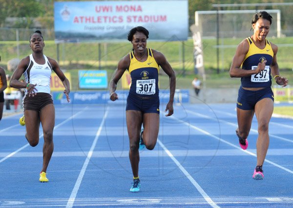 Ian Allen/Staff Photographer
Natasha Morrison right, Utech winning the Women's 200m finals ahead of her teammate Elaine Thompson centre and Kedisha Dallas left from G.C.Foster College during the VMBS Intercollegiate Track and Field Championship 2014 at the UWI/Usain Bolt Track.