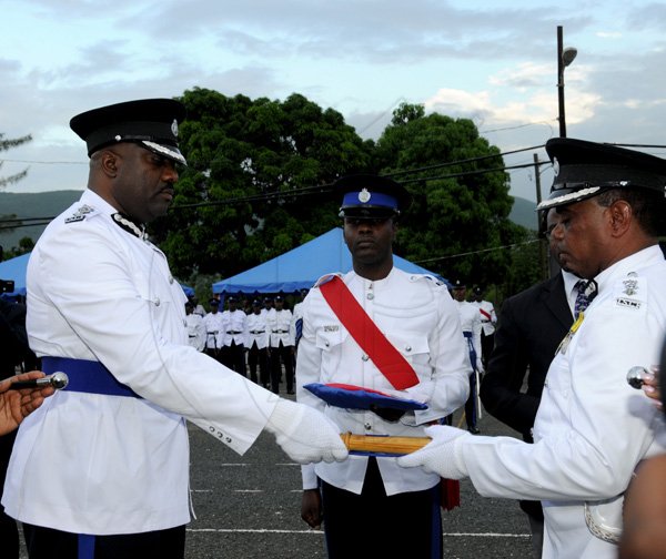 Winston Sill / Freelance Photographer
Island Special Constabulary Force (ISCF) Change of Command Parade for new Commandant James Golding, held at the ISCF Headquarters, Herman Barracks on Saturday October 6, 2012. Here new Commandant Golding (left), accepts the Baton from outgoing Commandant Osmond Bromfield (right);, at centre is Sgt. David Lowe.