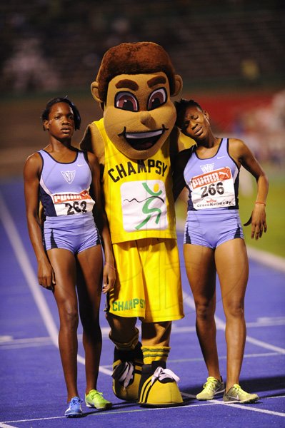 Ricardo Makyn/Staff Photographer
Left Marleena  Eubanks of Edwin Allen wininer  the Girls   Class 2  Girls 1500 Meters is congratulated with Teammate Sanikee Gardner by Champsy   at the Boys and Girls Championships at the National Stadium on Friday 30.3.2012