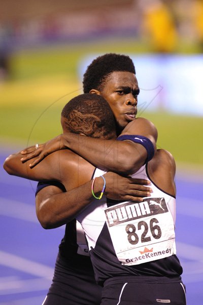 Ricardo Makyn/Staff Photographer
 Jamaica Colleges Javarn Gallimore is congratulated by a team mate after winning the  Boys open 400 Meters Hurdles Final   at the Boys and Girls Championships at the National Stadium on Friday 30.3.2012