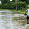 Ricardo Makyn/Staff Photographer
 A pedal Cyclist rides through heavy water after Rain fall in the Hartlands Community.