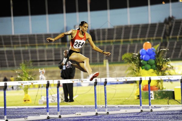 Ricardo Makyn/Staff Photographer
Kaliese Spencer clears the hurdle on her way to an easy victory in the women's 400 metres final, at the Jamaica Athletics Administrative Association/Supreme Ventures Limited National Senior Championships, at the National Stadium last night. Spencer won in 54.15 seconds.