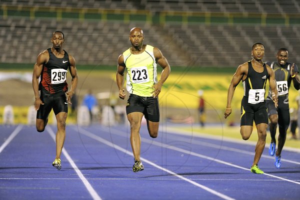 Ricardo Makyn
Asafa Powell (centre) is comfortable en route to victory during the quarter-finals of the men's 100m at the JAAA/SVL National Senior Championships inside the National Stadium last night. Powell won in a wind-aided 9.96 seconds. Kenroy Anderson (right) finished third in 10.15 while Ainsley Waugh (left) was fourth in 10.23.