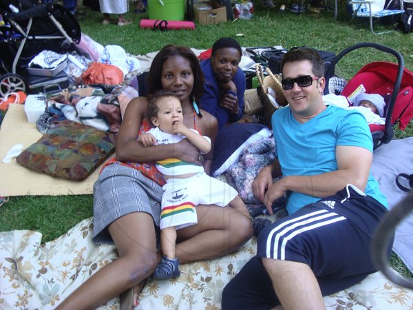 The Steinberg family baby Tuvia, dad Jason, his wife Jacqueline and her aunt Audrey relaxes at the Jamaica
 50th Fun Day and Picnic