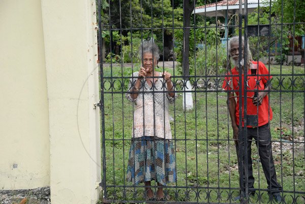 Jermaine Barnaby/Freelance Photographer
These two senior citizens take a peek s at Jamaica carnival road march on Sunday April 23, 2017 while they travelled along Hope road.