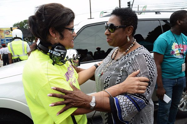 Jermaine Barnaby/Freelance Photographer
Julianne Lee (left) talking with Olivia Grange at Jamaica carnival road march on Sunday April 23, 2017.