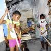 Norman Grindley/Chief Photographer
Seven-year-old Mickailla March (left) and Shadeka Hanson, 10, both members of the Hannah Town Police Youth Club in West Kingston, put in some Labour Day work on their burnt out police station yesterday. Residents turned out to clean debris from the station as they call for the authorities to rebuild the station.