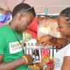 Jermaine Barnaby/Photographer
Knot'z Enterprise president, Sasha Miller of Wolmers High Scool was the first group to make a sale during the Jampreneurs Expo & Summer Jam at the  Ranny Williams Entertainment Centre on  Saturday, July 5, 2014. Purchasing a braclet is Neville Charlton.