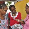 Jermaine Barnaby/Photographer
St Andrew High School, Kelly Griffith (right) tries to sell a "cake pop" to Chayanne Simpson (left) and Donna brissett at her Dulce Nueva booth during the Jampreneurs Expo & Summer Jam at the  Ranny Williams Entertainment Centre on  Saturday, July 5, 2014.