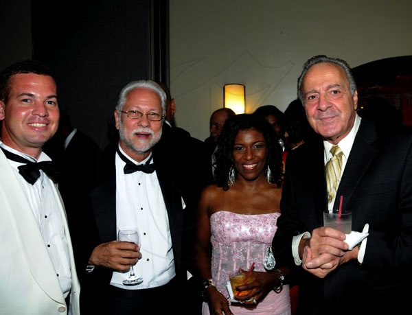 Winston Sill / Freelance Photographer
Veteran businessman Horace Bogues (second left) and son Arthur (following in dad's footsteps) lyme with Scotiabank's Denise Coubry and attorney Ade Dabdoub.

The Civic Affairs Committee of the Jamaica Chambern of Commerce 30th annual Grand Charity Ball, held at the Jamaica Pegasus Hotel, New Kingston on Saturday night November 5, 2011.