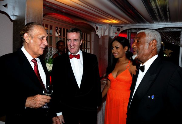 Winston Sill / Freelance Photographer
Veteran entrepreneur Michael Ammar Snr (left) spins a tale for Digicel Jamaica CEO Mark Linehan (second left), his wife Leisha, and Ray Campbell.

The Civic Affairs Committee of the Jamaica Chambern of Commerce 30th annual Grand Charity Ball, held at the Jamaica Pegasus Hotel, New Kingston on Saturday night November 5, 2011.