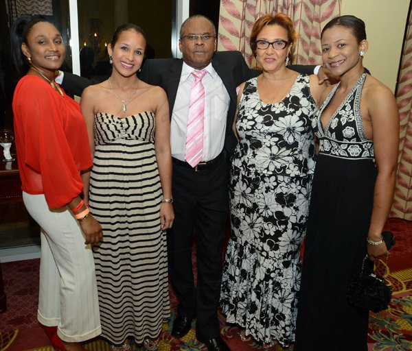 Rudolph Brown/Photographer
Raymond Walter, CEO of Caribbean Assurance Brokers pose with from left Elizabeth Budhu, Lesley Touzalin, Marigold Naar and Nicole Walker at the JCCUL 72nd anniversary Dinner and awards Banquet at the Ritz Carlton on Saturday, May 17, 2013
