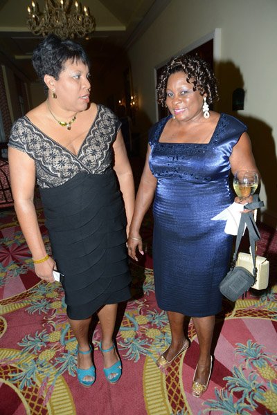 Rudolph Brown/Photographer
Dianna Blake-Bennet, (left) Marketing and Event Manager of Centralized Strategic Services (CSS) chat with  Hope Mowatt at the JCCUL 72nd anniversary Dinner and awards Banquet at the Ritz Carlton on Saturday, May 17, 2013
