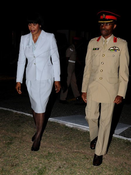 Winston Sill / Freelance Photographer
Brigadier Rocky Meade of The Jamaica Defence Force escorts Prime Minister Portia Simpson Miller to the army's annual Carol Service in the Open Air, held at Up Park Camp on Tuesday night December 11, 2012.