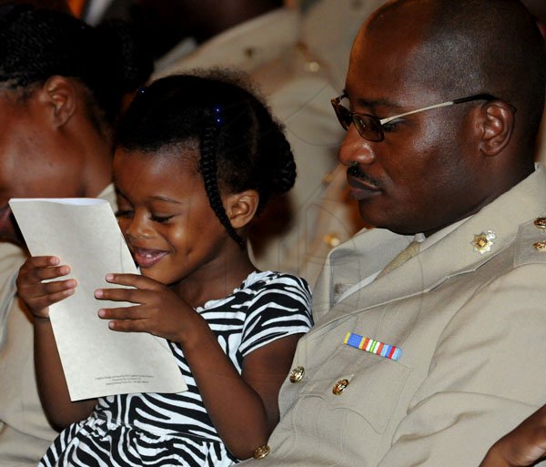 Winston Sill / Freelance Photographer
The Jamaica Defence Force (JDF) annual Carol Service in the Open Air, held at Up Park Camp on Tuesday night December 11, 2012. Here are Kayla Williams (left); and her dad Major Roderick Williams.