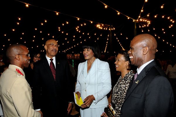 Winston Sill / Freelance Photographer
Governor General Sir Patrick Allen (second left) and Prime Minister Portia Simpson Miller (centre) reflect on an entertaining Carol Service with (from left) Brigadier Rocky Meade, Sonia Fuller and Steadman Fuller, custos of Kingston.

The Jamaica Defence Force (JDF) annual Carol Service in the Open Air, held at Up Park Camp on Tuesday night December 11, 2012.