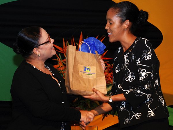 Colin Hamilton/Freelance Photographer
Launch of the JIS Photo Album tho commemorate Jamaica 50th Anniversary at the Pegasus on July 18, 2012.
From left, Information Minister Sandrea Falconer receives a copy of the album from the CEO of the JIS Donna-Marie Rowe.