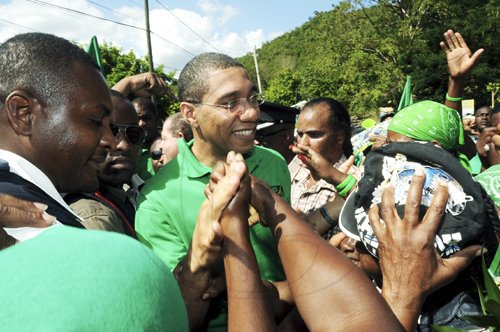 Ian Allen/Photographer
Prime Minister Andrew Holness is greeted by supporters at Whitney Turn in Manchester during a tour of the parish yesterday.