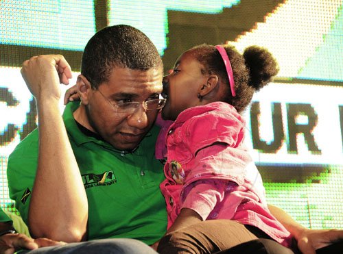 Gladstone Taylor / Photographer
Prime Minister Andrew Holness listens to a little one during his dash across the country earlier this week.