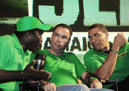 Gladstone Taylor / Photographer
Bobby Montague (left), JLP deputy chairman, has the attention of Darly Vaz (centre) and Prime Minister Andrew Holness at a JLP meeting in St Mary on Wednesday night.
