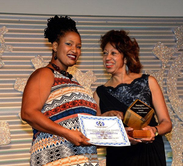 Winston Sill/Freelance Photographer
BUSINESS DESK:---The Jamaica Manufacturers' Association Limited (JMA) in association with Digicel host the 46th Annual Awards Banquet, held at the Jamaica Pegasus Hotel, New Kingston on Thursday night October 9, 2014. Here are Antoinette Morgan-Burt (left) Brand Manager, Honey Bun Limited; collecting the JAMPRO Award from  JAMPRO's . President???.