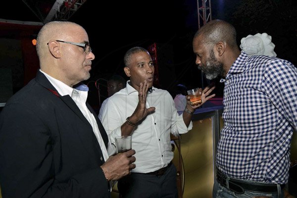 Ian Allen/Photographer<\n><\n>Top Agent, CEO of JMMB Group, Keith Duncan is seen discussing covert missions with Investment Advisor Leacroft Forden and Managing Director of Flow Jamaica, Garry Sinclair. <\n><\n>JMMB Covert Ops, Chinese Garden, Hope Gardens.