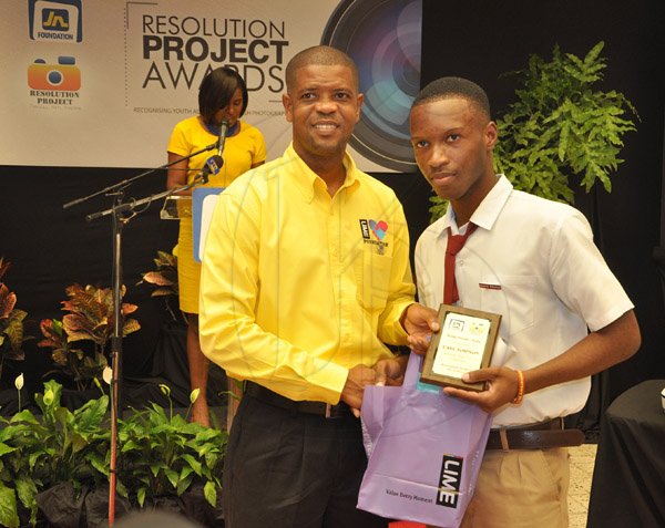 Jermaine Barnaby/Photographer
Carl Simpson collecting the best Selfy prize at the  JN Foundation Resolution Project Awards Ceremony at the Olympia Gallery- 202 Old Hope Road on Tuesday, July 15, 2014.