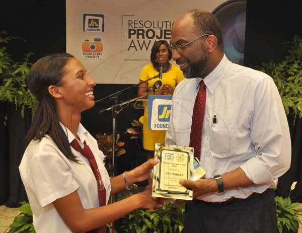 Jermaine Barnaby/Photographer
Earl Jarrett, General Manager of JNBS hands over the JN Foundation Resolution Project general managers award to Jodi Morgan at the Awards Ceremony at the Olympia Gallery- 202 Old Hope Road on Tuesday, July 15, 2014.