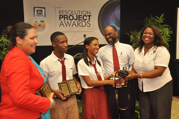 Jermaine Barnaby/Photographer
Terry-Ann Wilson (right) Assistant Manager, Business Development and Marketing The Gleaner Company hands over a camera to Jodi Morgan (third left)who won an intership at the Gleaner after copping the Emerging Photo Advocate award at the JN Foundation Resolution Project Awards Ceremony at the Olympia Gallery- 202 Old Hope Road on Tuesday, July 15, 2014. Looking on is Earl Jarrett (second right) General Manager of JNBS, Carl Simpson (second left) an awardee and Saffrey Brown (left) General Manager Jamaica National Building Society Foundation