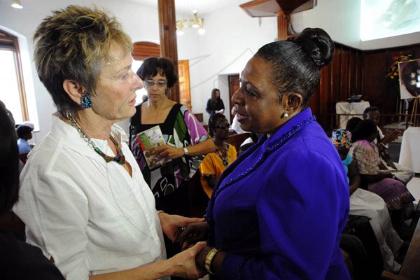 Rudolph Brown/Photographer
Dr Marjan DeBruin, (left) wife of the late John Maxwell greets by Minister Olivia Grange at the funeral sevice of John Maxwell at UWI Chapel on Monday, December 20-2010