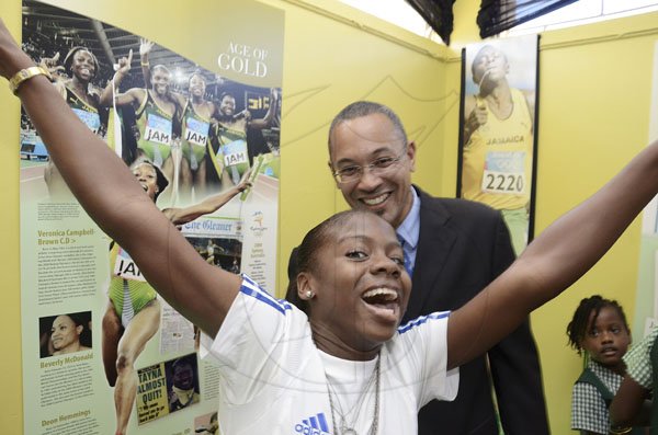 Rudolph Brown/Photographer
The Gleaner's Managing Director Chris Barnes looks on in amusement as national junior sprint hurdler Megan Simmonds (front) jumps around in excitement during the launch of The Gleaner/Scotiabank 'The Journey of Champions: 50 Years of Jamaican Athletic Excellence' exhibition at the St Catherine Parish Library on Wednesday. 




Launch of The Gleaner/Scotiabank Photo exhibition at St. Catherine Parish Library, Spanish Town on Wednesday, February 1-2012