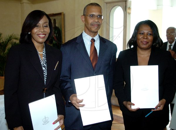 Winston Sill/Freelance Photographer
Newly sworn members of the judiciary pose after a ceremony in their honour at King's House in St Andrew on Tuesday. From left are Nicole Simmons, who will act as puisne judge; Justice Patrick Brooks, who will deputise as judge in the Court of Appeal; and Resident Magistrate Sharon Ayton-George, who will act as master-in-chambers. 

Governor Genertal Sir Patrick Allen conduct Swearing-in Ceremony of three Judges to act in the Court of Appeal, Puisne Judge, and Master-In-Chambers, held at Kings House, Hope Road on Tuesday April 6, 2010. Here are Her Honour Miss Justice Nicole Adrianne Simmons (left), act as Puisne Judge; His Honour Mr. Justice Patrick Anthony Brooks (centre), Judge Court of Appeal; and Her Honour  RM Sharon Rose-Marie Ayton-George (right), act as Master-In-Chambers.