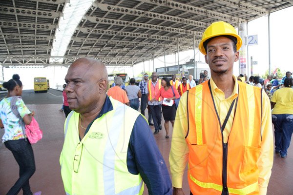 Rudolph Brown/Photographer
Colin Campbell (left) managing director JUTC and Deputy Managing Director with responsibility for Operations at the Jamaica Urban Transit Company (JUTC), Kirk Finnikin  tour JUTC Transport Centre in Half Way Tree in Kingston on Wednesday, August 27, 2014