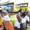 Rudolph Brown/Photographer
Colin Campbell (right) managing director JUTC speaks to passengers waiting to get there smart card to board a JUTC bus in Half Way Tree during a tour in Kingston on Wednesday, August 27, 2014