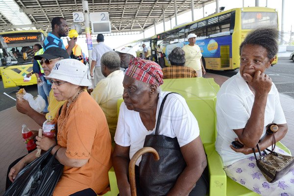 Rudolph Brown/Photographer
Passengers waiting to get there smart card to board a JUTC bus in Half Way Tree in Kingston on Wednesday, August 27, 2014