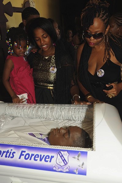 Ian Allen/Photographer
Kimberly Mais second left and her daughter Nica  along with cousin Sandy Stewart look at the body of Khajeel Mais while attending the funeral service at the Holy Trinity Cathedral on saturday.