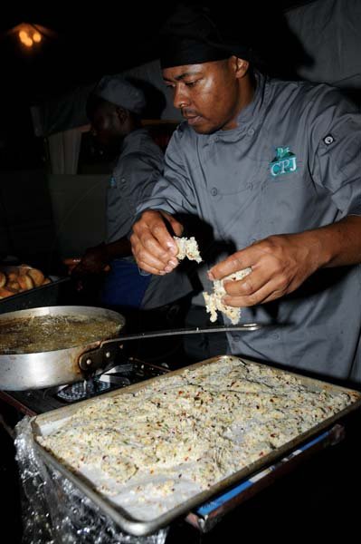 Winston Sill/Freelance Photographer
Chef Oneil Murdock of CPJ cooking the Sesame Crusted Snapper
Kgn. Kitchen Night Market, held at Hope Gardens, Old Hope Road on Saturday night August 24, 2013.