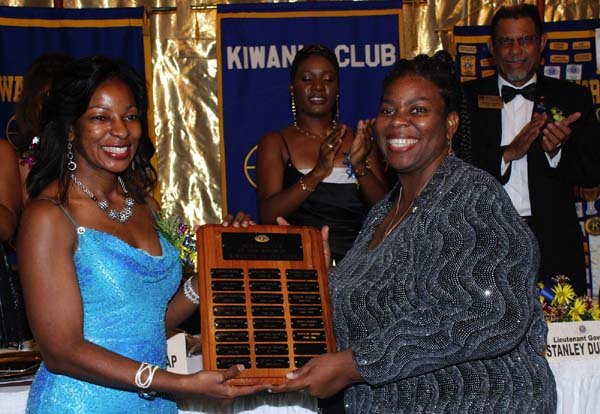 Colin Hamilton/Freelance Photographer
At left,  IPP Andrea Moore presents a plaque to Kiwanian of the year Natalie Moore at the Kiwanis Club of New Kingston Installation Banquet at the Jamaica Pegasus on Wednesday October 12, 2011.