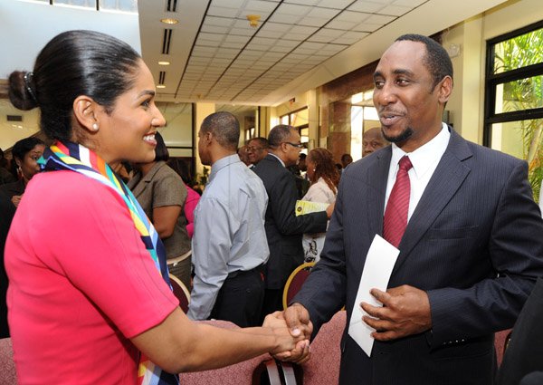 Ricardo Makyn/Staff Photographer
Minister of Youth and Culture the Hon Lisa Hanna is greeted by Oneil Grant , president of the Jamaica Civil Service Association  at the launch of National Labour DAY 2013 at the office of the Prime Minister on Monday13.5.2013