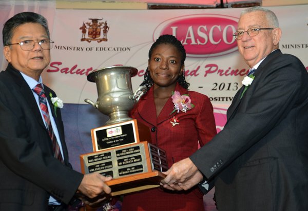 Rudolph Brown/Photographer
Lascelles Chin, (left) executive chairman of LASCO Affiliated Companies and Rev. Ronald Thwaites, Minister of Education (right) presents trophies to Dageama Spencer-Hull teacher of the year from Holland High School, (centre) the LASCO/Ministry of Education principal of the year 2012-2013 Teacher and Principal of the Year Awards at the Wyndham Hotel in New Kingston on Tuesday, December 4, 2012