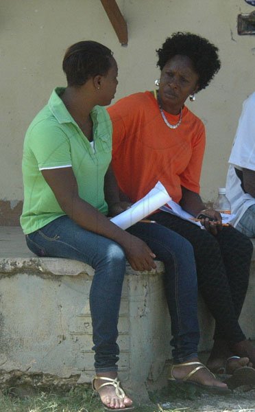 Photo by Adrian Frater

Sharing their boredom...a PNP party worker and her JLP counterpart in conversation in Sandy Bay, Hanover.