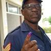 Rudolph Brown/Photographer
Sgt. Kennedth Doyley show his finger after his vote goes into the ballot box before the Local Government election at Mobile Reserve in Kingston on Friday November 25, 2016.