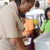 Rudolph Brown/Photographer
Inspector Janet Hylton, put her finger in the ink after watches her vote goes into the ballot box before the Local Government election at Mobile Reserve in Kingston on Friday November 25, 2016.