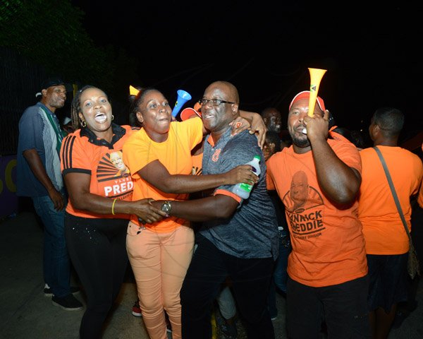 Ian Allen/Photographer
Vanrick Preddie (centre) PNP Councillor in the Portmore Municipality, is being congratulated by supporters after he was declared winner at the counting centre at the Ascot High school.