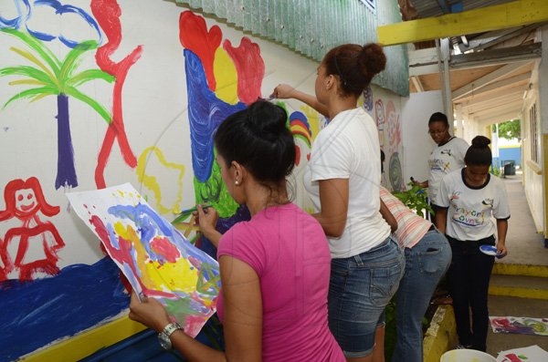 Rudolph Brown/Photographer
Gleaner Involvement in Nelson Mandela Day ( Painting a mural) Reading to the Children in the classrooms colouring activity at Jamaica House Basic School on Wednesday, July 18-2012