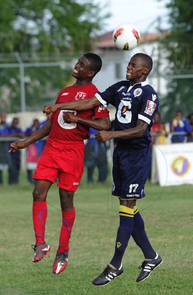 Ricardo Makyn/Staff Photographer
Left Camperdown High Schools' Rohan Scott and   Jamaica College's Akeno Bailey vie for the Ball  in their Manning Cup encounter at Bellevue on Friday 14.9.2012