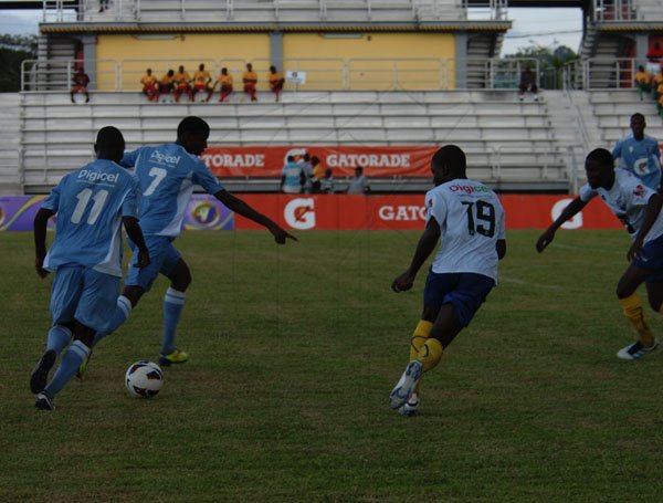 DSC_0045............THIS WAY: That is what this St. George’s College player appears to be telling his teammate, during their Manning Cup opener against Hydel in their 1-1 drawn game on Saturday at the Catherine Hall Sports Complex.