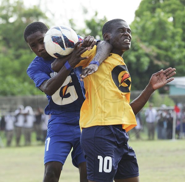 Ricardo Makyn/Staff Photographer
Left Norman Manley High's Deshawn Morrison and Penwood Highs Romario Williams vie for the Ball in their match at Maxfield Park  on Friday 14.9.2012